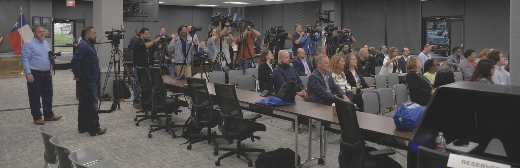 Press conference room with reporters and cameras at an NCTCOG meeting
