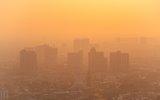 An aerial view of a city with smog