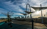 A pedestrian bridge in Dallas with a blue sky