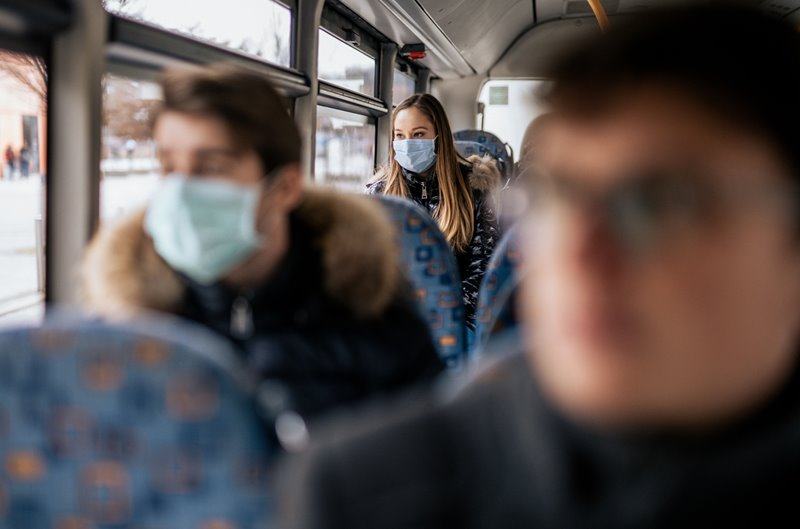This is an image of bus riders wearing masks