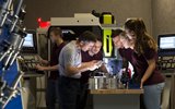 Men and women around a bore micrometer and vernier