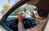 Car driver stopping quickly in front of bicycler