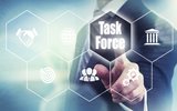 Person pointing to a button labeled Task Force