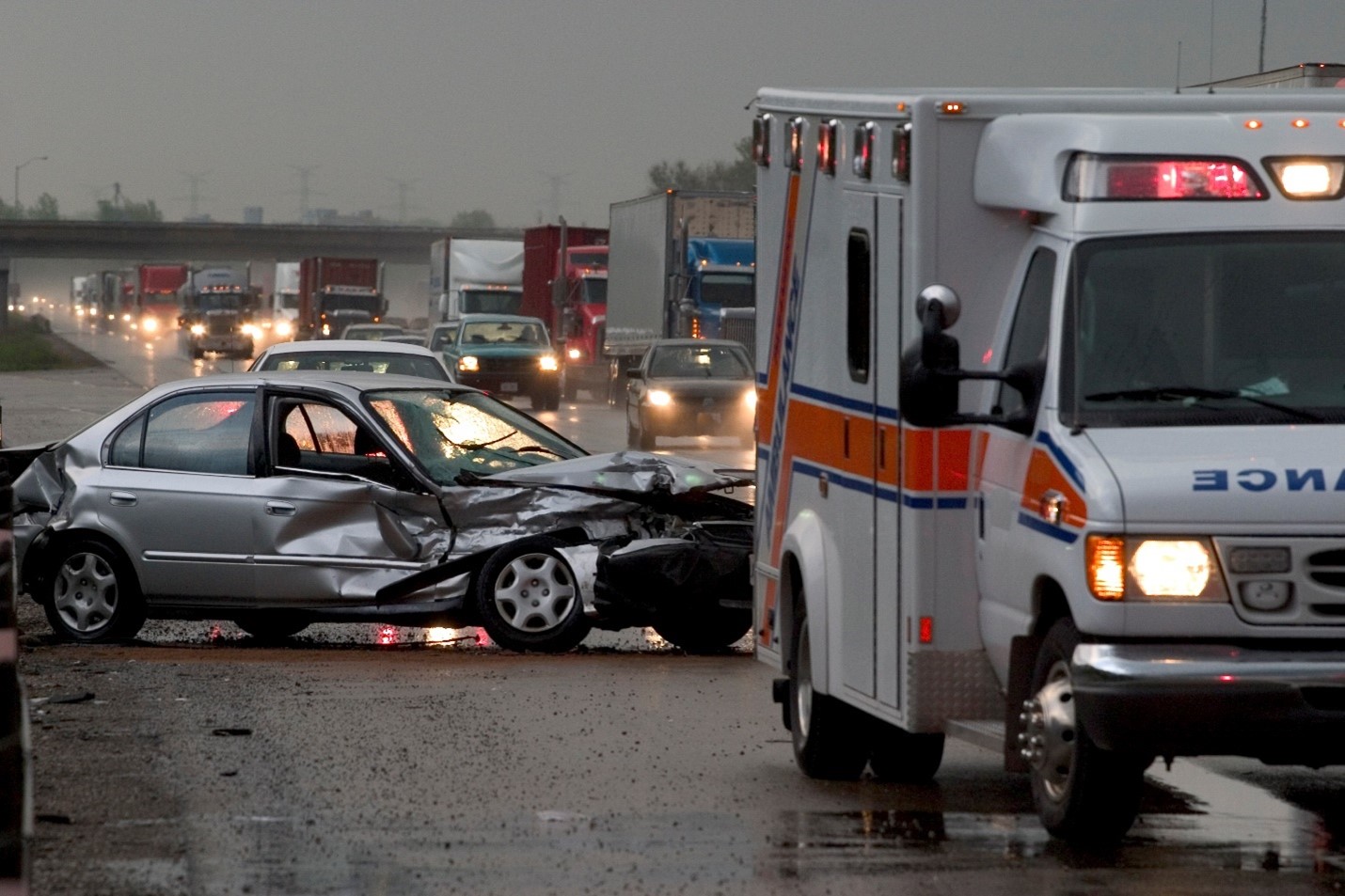 Crashed vehicle and ambulance on highway