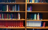 Shelf with several books and printed resources