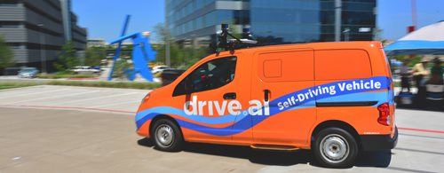 This is an image of a orange drive.ai self driving vehicle