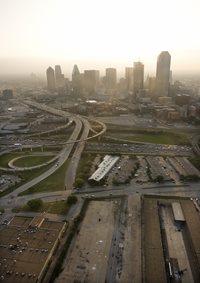 This is a zoomed out image of downtown dallas showing the foggy skyline, making an example out of air pollution in the metropolitan area.